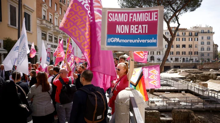 A woman holds a banner during a demonstration in support of surrogate motherhood in Rome, Italy, April 5, 2024. Banner reads: "We are families not crimes". REUTERS/Guglielmo Mangiapane/File photo