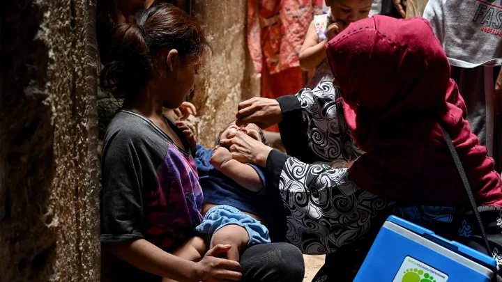 A health worker administers polio vaccine drops to a child during a vaccination campaign in Karachi on June 3, 2024. Asif Hassan/AFP/Getty Images