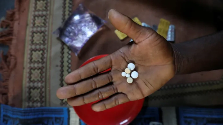 Sodiq Ajibade, 29, who suffers from asthma attacks, displays his medication in his home in Lagos, Nigeria [File: Temilade Adelaja/Reuters]