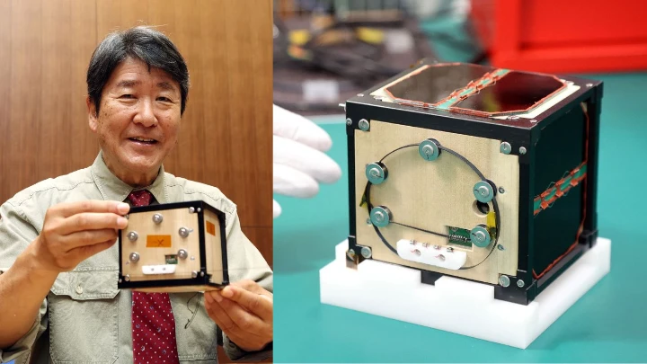 This file photo taken on 28 May 2024 shows Takao Doi, an astronaut and special professor at Kyoto University, holding the world's first wooden satellite, named LignoSat, during a press conference at the university's campus in Kyoto. Photo: AFP