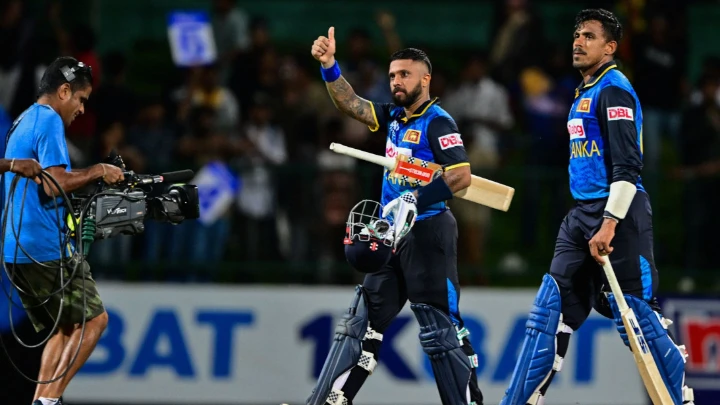 Sri Lanka's Kusal Mendis (C) and Maheesh Theekshana (R) celebrate their team's victory in the second ODI against New Zealand at the Pallekele International Cricket Stadium in Kandy on November 17, 2024. PHOTO: AFP