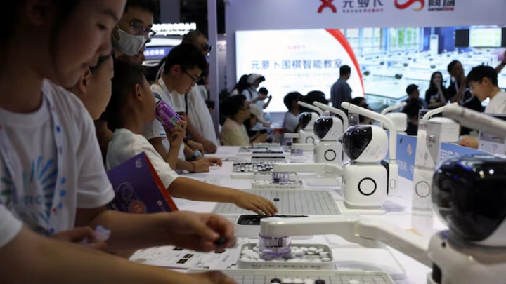 Visitors play Go against SenseRobots displayed at the SenseTime booth during the World Robot Conference in Beijing, China August 21, 2024. REUTERS/Florence Lo/File Photo 