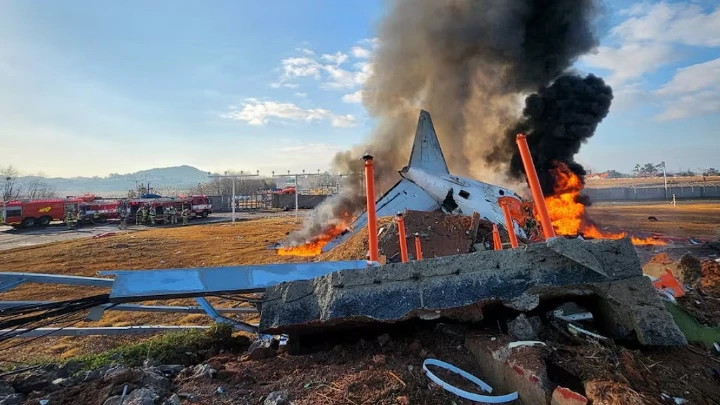 Firefighters carry out extinguishing operations on an aircraft which drove off runaway at Muan International Airport in Muan, South Jeolla Province, South Korea, December 29, 2024. Photo: Yonhap via REUTERS