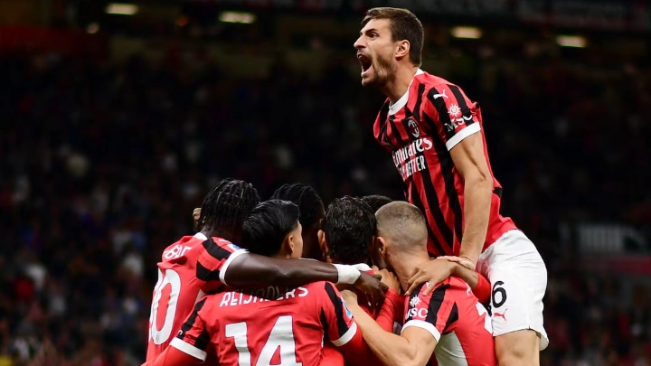  Soccer Football - Serie A - AC Milan v Venezia - San Siro, Milan, Italy - September 14, 2024 AC Milan's Theo Hernandez celebrates scoring their first goal with Matteo Gabbia and teammates REUTERS/Daniele Mascolo