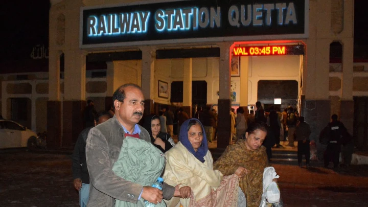 Passengers who were rescued from a train after it was attacked by separatist militants, walk with their belongings at the Railway Station in Quetta, Balochistan, Pakistan, March 12, 2025. REUTERS/Stringer